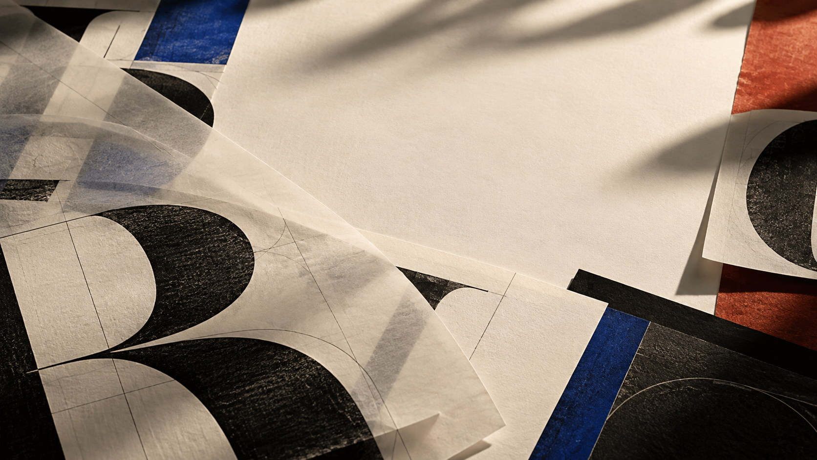 Large serif letterforms printed on layered paper sheets in warm light